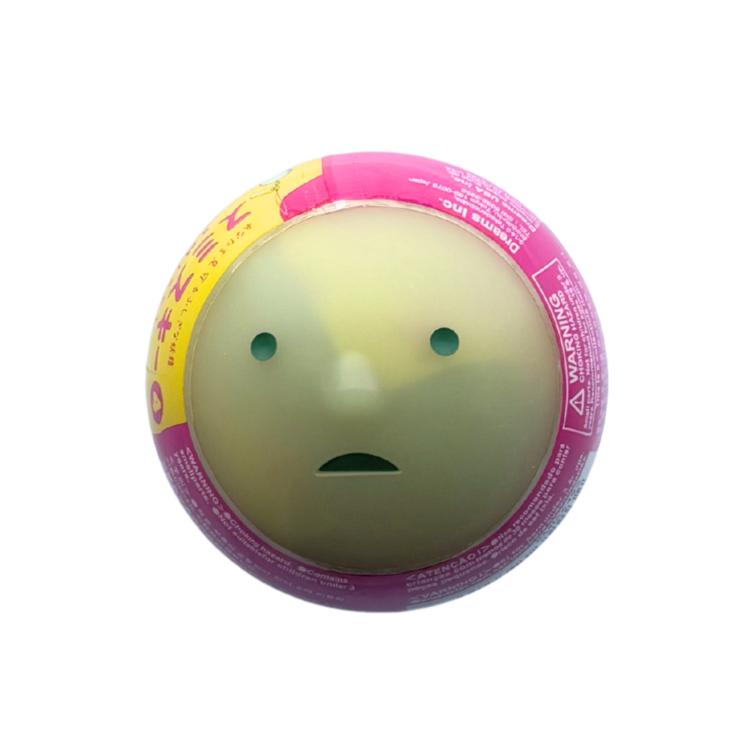 A round Smiski yellow-green face printed on the front, surrounded by a pink and yellow printed rim with warning text and Japanese characters, isolated on a white background.