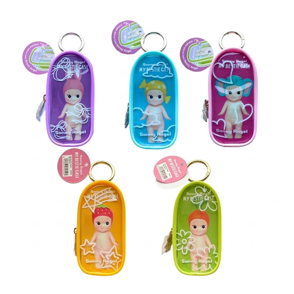 Five small oval Sonny Angel keychain-style cases with colorful plastic fronts and attached tags, each showing a cartoon baby doll inside. The cases are purple, blue, pink, yellow, and green, arranged on a white background.